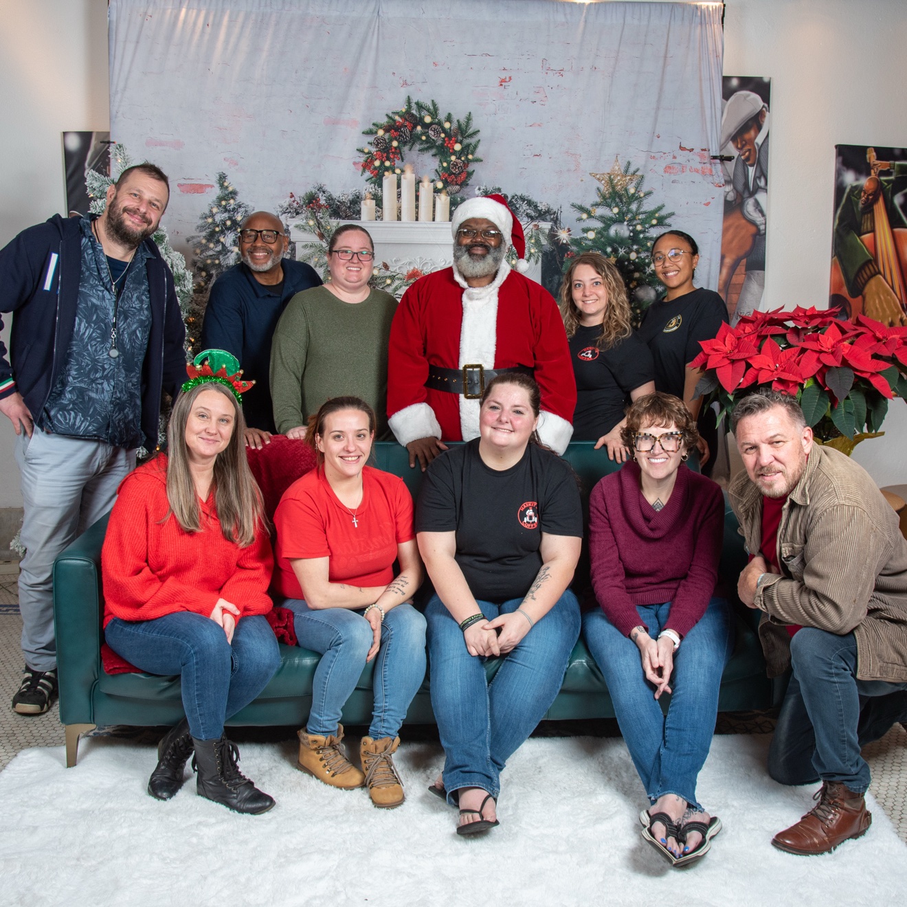 Family of four posing with Santa at PVME Family Christmas Pictures