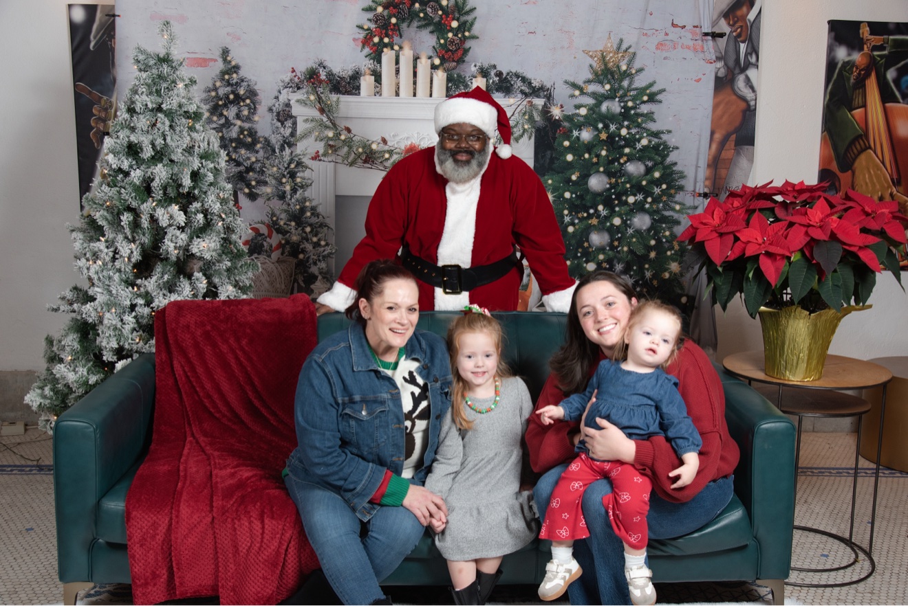 Young girl in Christmas dress with Santa at PVME Family Christmas Pictures